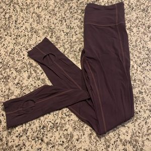 Purple Athleta leggings with ankle cutouts